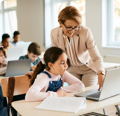 happy-teacher-assisting-schoolgirl-in-using-laptop-2023-11-27-05-18-10-utc